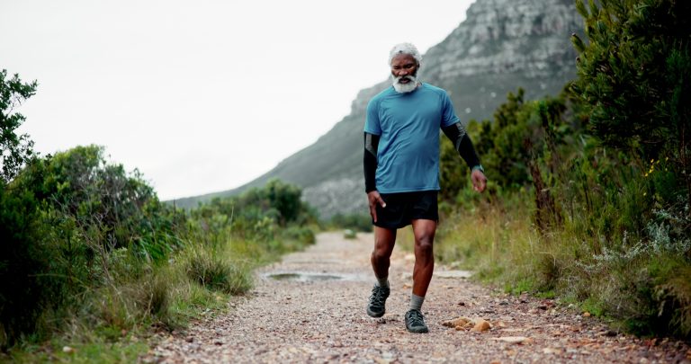 Hip pain, senior black man and injury in nature for fitness, workout or training with accident. Run